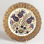 A GOOD ZSOLNAY CIRCULAR SHAPED DISH, gilt decoration and rich blue flowers. 12ins diameter.