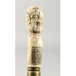 A WALKING STICK the bone handle carved as a phrenology head.