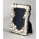 A SMALL SILVER PHOTOGRAPH FRAME, embossed with Teddy bears. 4ins x 3ins.
