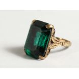 A 9CT GOLD AND GREEN-STONE RING.