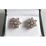 A GOLD PAIR OF 9CT GOLD, DIAMOND DAISY CLUSTER EARRINGS.