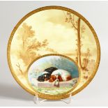 A SUPERB MINTON PLATE painted with spaniels after Landseer, puce globe and crown mark.