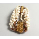 A PEARL BRACELET with decorative clasp.