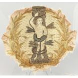 A 17TH CENTURY STUMPWORK TYPE TEXTILE FRAGMENT of ADAM. Stuck on to a piece of glass which is AF.