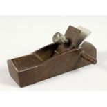 A SMALL BRONZE MODEL OF A WOODWORKING PLANE. 3.5ins long.