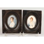 A PAIR OF OVAL PORTRAIT MINIATURES in wooden frames. 3ins x 2ins. Monogrammed.