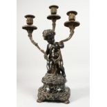 A GOOD 19TH CENTURY FRENCH BRONZE AND ORMOLU THREE BRANCH CANDELABRA formed as a cupid holding three