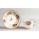 AN EARLY 19TH CENTURY BREAKFAST CUP AND SAUCER with sprays of flowers and gold ribbons, printed with