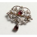 A 9CT GOLD AND SILVER, GARNET AND SEED PEARL BROOCH.