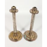 A PAIR OF ART DECO STYLE COLUMN SHAPE CANDLESTICKS on circular bases. 14.5ins high.