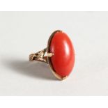 A GOLD AND CORAL RING.