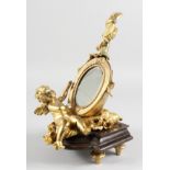 A GILT BRONZE TABLE MIRROR modelled as a cherub holding a lute. 12ins high.