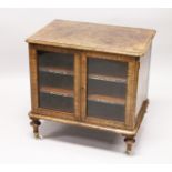 A VICTORIAN WALNUT LOW TWO DOOR MUSIC CABINET, with two shelves, on turned feet. 2ft 3ins wide x 2ft