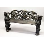 A "BLACK FOREST" CARVED WOOD BENCH SEAT, the naturalistically carved seat with a bear being
