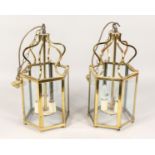 A PAIR OF BRASS HEXAGONAL SHAPED HALL LANTERNS. 17.5ins high.