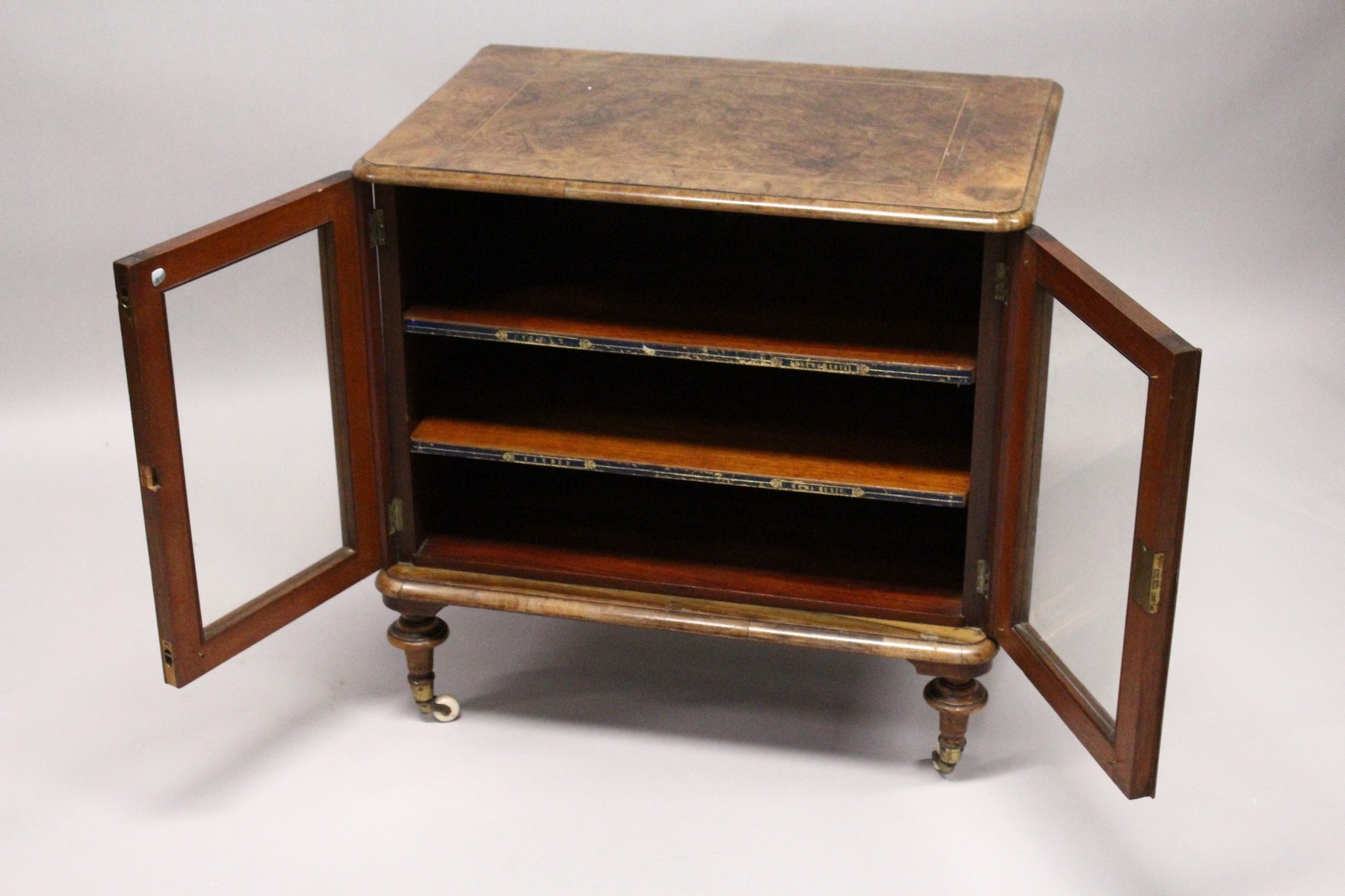 A VICTORIAN WALNUT LOW TWO DOOR MUSIC CABINET, with two shelves, on turned feet. 2ft 3ins wide x 2ft - Image 4 of 4