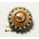 A GOLD AND TURQUOISE BROOCH.