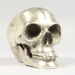 A PLATED MODEL OF A HUMAN SKULL. 5ins long.