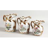 A GARNITURE OF THREE LUSTRE JUGS. 7ins, 6.5ins and 5ins high.