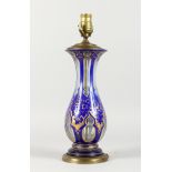 A GOOD BOHEMIAN BLUE AND GILT GLASS LAMP with gilt mounts. 16ins high.