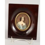 AN OVAL PORTRAIT MINIATURE OF A YOUNG LADY in a wooden frame. 2.5ins x 2ins. Signed.