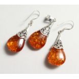 A SILVER AND AMBER PENDANT with a pair of matching earrings.