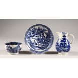 A WILLOW PATTERN BLUE AND WHITE TEA BOWL AND SAUCER, unusual mark, and A SPARROW BEAK JUG. (3)