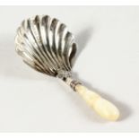 A GEORGIAN SILVER SHELL SHAPED CADDY SPOON.