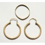 A PAIR OF GOLD HOOP EARRINGS and a large ring.