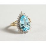 A 9CT GOLD PEAR SHAPED BLUE TOPAZ AND DIAMOND RING.