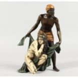 A VIENNA STYLE COLD PAINTED BRONZE OF AN ARAB MAN AND A WOMAN. 5.75ins high.