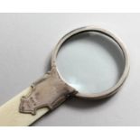 A SILVER MOUNTED IVORY MAGNIFYING GLASS. Birmingham 1910. 8.5ins long.