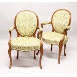A GOOD PAIR OF FRENCH BEECH WOOD ARMCHAIRS with padded back and seats.