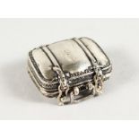 A MINIATURE SILVER SUITCASE.