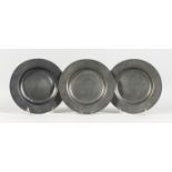 THREE EARLY PEWTER CIRCULAR PLATES, stamped LONDON. 7.75ins diameter.