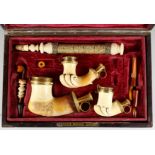 A SUPERB QUALITY SET OF THREE CARVED MEERSCHAUM PIPES of various sizes, mounted in silver gilt,