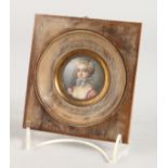 AFTER DE GREUZE. A CIRCULAR PORTRAIT MINIATURE OF A YOUNG LADY in a wooden frame, see reverse. 1.