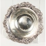 TIFFANY & CO, A STERLING SILVER CIRCULAR BOWL, with floral cast rim. 17ozs. 10ins diameter.
