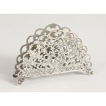 A PIERCED FAN SHAPED SILVER LETTER RACK.