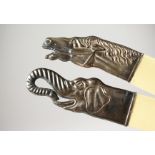 TWO RUSSIAN SILVER HANDLED PAGE TURNERS modelled as an elephant's head and a horse's head. 10ins