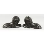 AN EARLY PAIR OF CAST IRON LIONS. 5.5ins long.