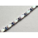 A GOOD SILVER, SAPPHIRE AND OPAL LINE BRACELET.