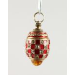 A RUSSIAN SILVER AND ENAMEL MINIATURE EGG SHAPED PENDANT.