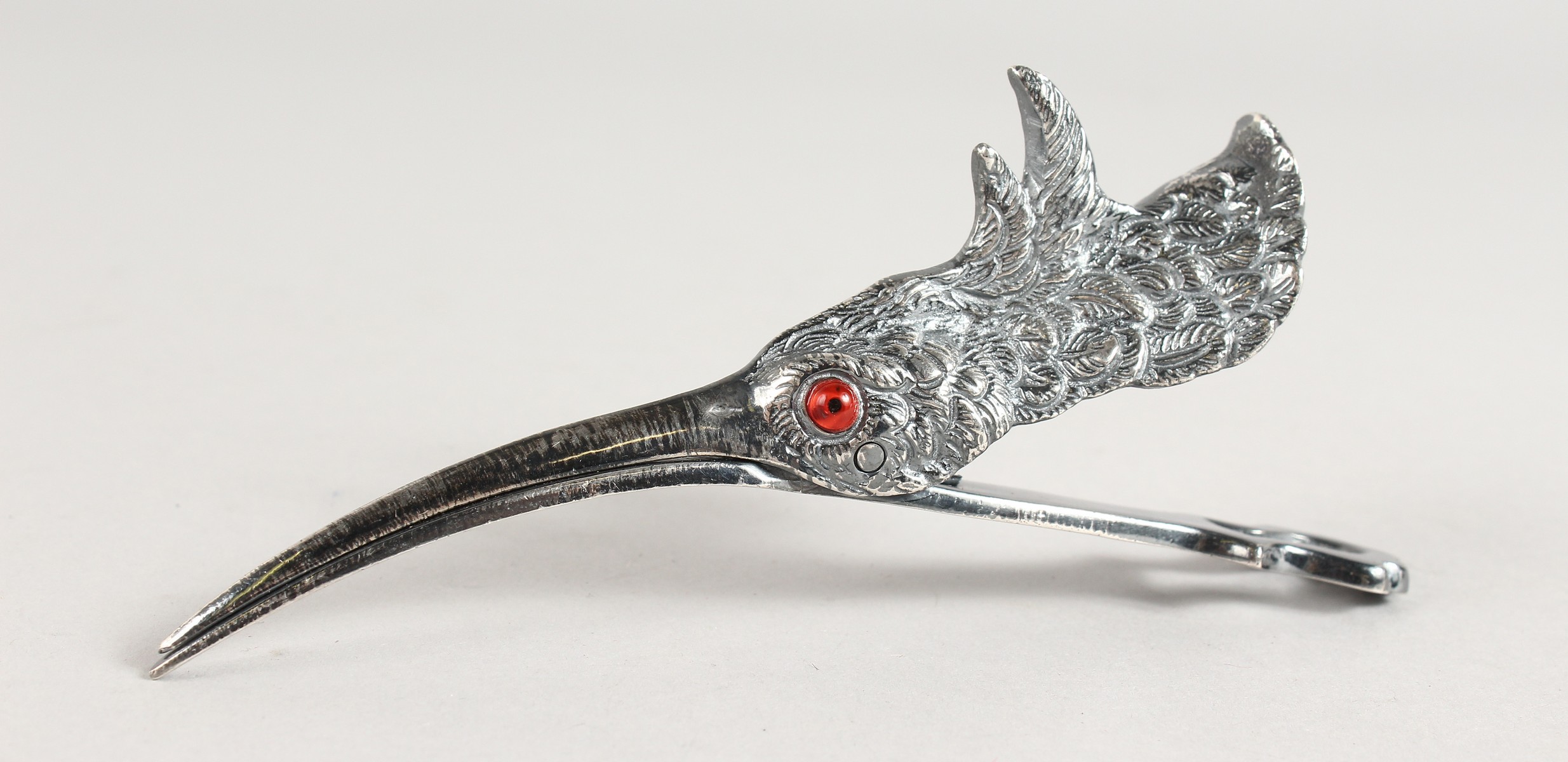A PLATED LETTER CLIP modelled as a snipe's head.