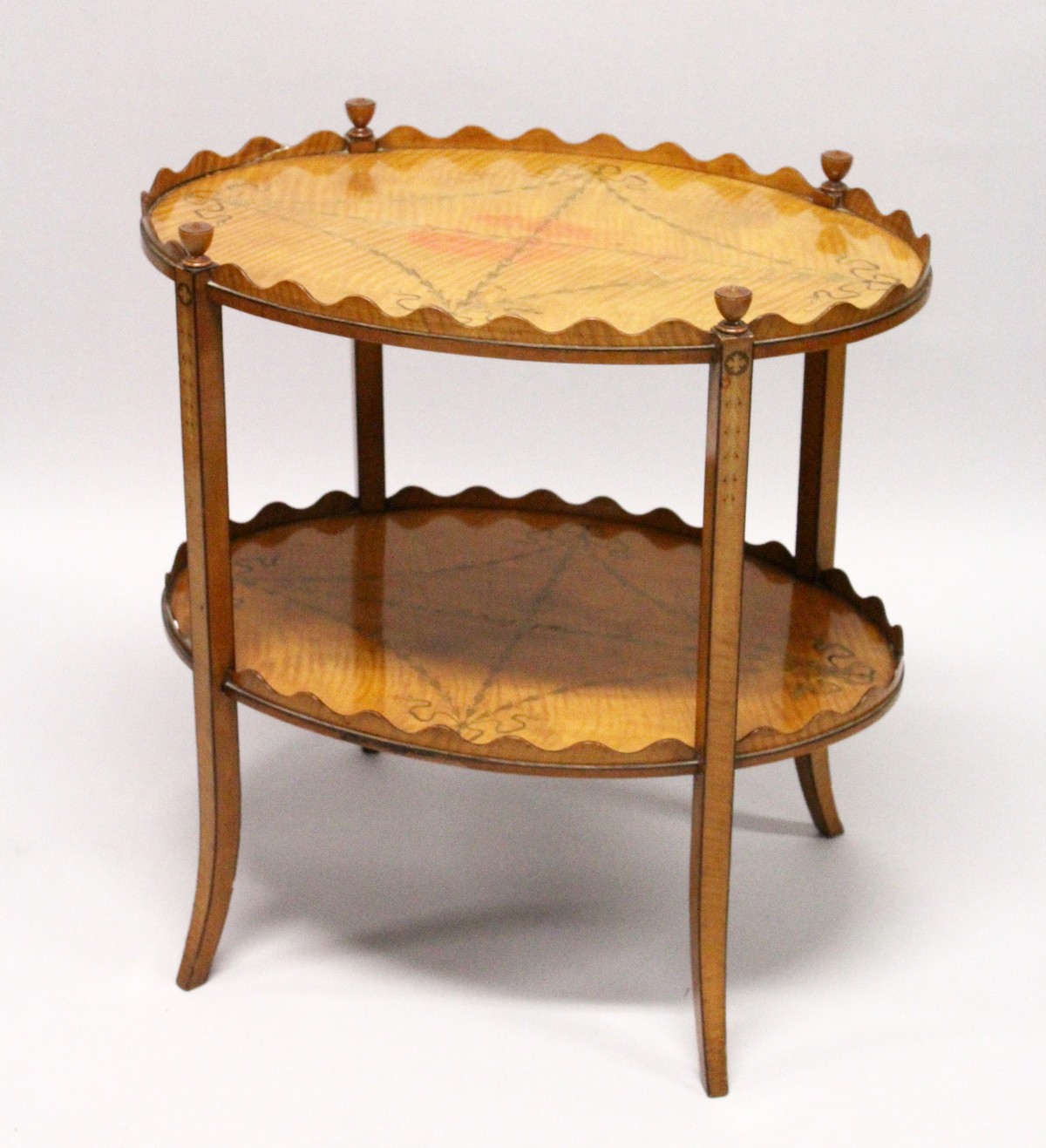 A GOOD SHERATON REVIVAL SATINWOOD AND MARQUETRY TWO TIER OVAL ETAGERE, the galleried top and