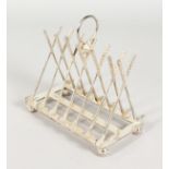 A NOVELTY PLATED GOLFING TOAST RACK.