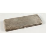 A RECTANGULAR HINGED SILVER BOX containing an early pair of spectacles. 4.75ins long.