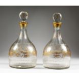 A VERY GOOD PAIR OF GEORGIAN MALLET DECANTERS AND STOPPERS, with gilt decoration, ribbons, etc.