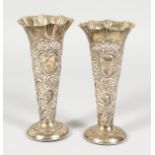 A PAIR OF TAPERING REPOUSSE SPILL VASES, with plain loaded circular bases. 6ins high. Chester 1899.