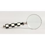 A MAGNIFYING GLASS.